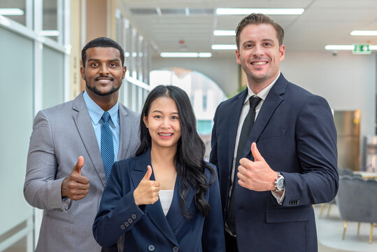 A group of business professionals giving thumbs up.
