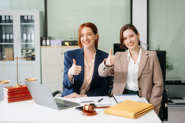 Professional female lawyers consulting on legal cases in a modern office. Perfect for law, business, justice