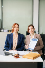 Obraz premium Professional female lawyers consulting on legal cases in a modern office. Perfect for law, business, justice