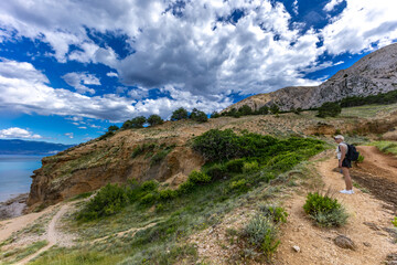 Hiking trail leading from the beach in Baska to the Bag mountain, city panorama seen from above,