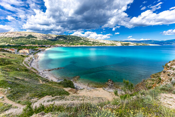 Obraz premium Hiking trail leading from the beach in Baska to the Bag mountain, city panorama seen from above,