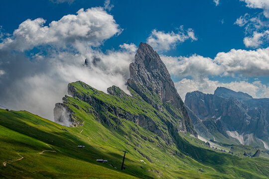 Majestic Seceda Peaks Emerging from Clouds in the Dolomites