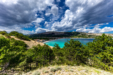 Hiking trail leading from the beach in Baska to the Bag mountain, city panorama seen from above,