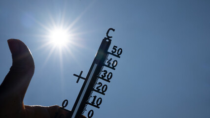 Hot weather, global climate change concept - Heat wave / Summer heat temperature celsius background banner long - Thermometer blue sky and sun rays