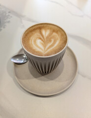 Close Up of an Oat Milk Latte Coffee in White Cup with Love Heart