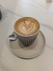 Close Up of an Oat Milk Latte Coffee in White Cup with Love Heart