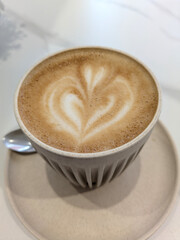 Close Up of an Oat Milk Latte Coffee in White Cup with Love Heart