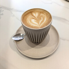 Close Up of an Oat Milk Latte Coffee in White Cup with Love Heart