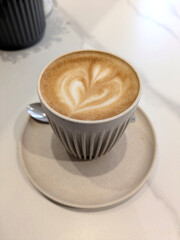 Close Up of an Oat Milk Latte Coffee in White Cup with Love Heart