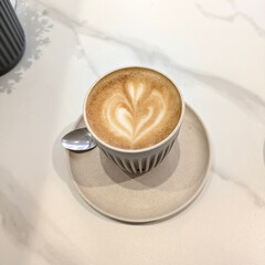 Close Up of an Oat Milk Latte Coffee in White Cup with Love Heart
