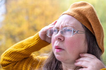 mature woman experiencing hot flashes due to menopause and high blood pressure, high blood pressure. Health concerns