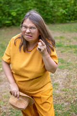 Angry mature white woman 50 years old with long hair expressing stress and frustration, reacting with anger and tension