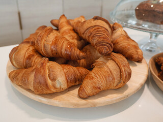 Fresh classic croissants on a plate