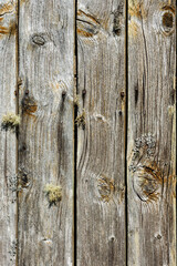 Close-up view of weathered wooden planks showing intricate textures and natural colors, highlighting the beauty of aged wood outdoors.