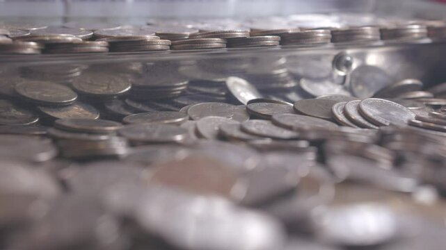 Stacks of quarters in pusher game at arcade 4k

