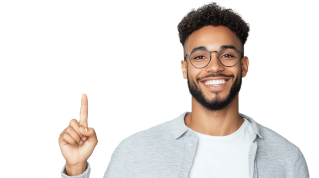 Smiling young man with glasses pointing upwards, expressing positivity and enthusiasm against a white background.