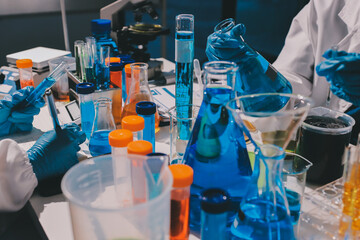 Scientist pipetting medical samples into microplate in laboratory