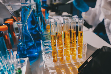 Scientist pipetting medical samples into microplate in laboratory
