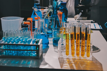 Scientist pipetting medical samples into microplate in laboratory