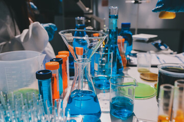 Scientist pipetting medical samples into microplate in laboratory