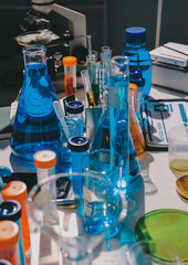 Scientist pipetting medical samples into microplate in laboratory