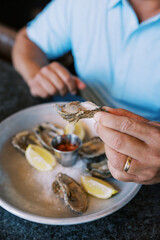 man eating oysters