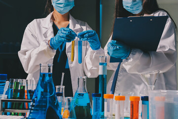 Scientist pipetting medical samples into microplate in laboratory