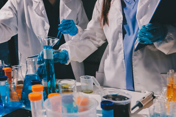 Scientist pipetting medical samples into microplate in laboratory