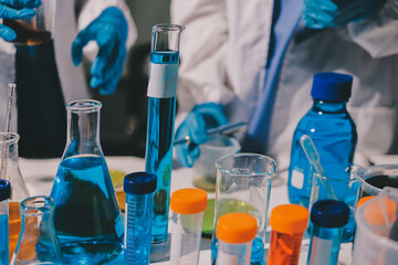 Scientist pipetting medical samples into microplate in laboratory