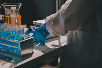 Scientist pipetting medical samples into microplate in laboratory