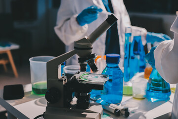 Scientist pipetting medical samples into microplate in laboratory