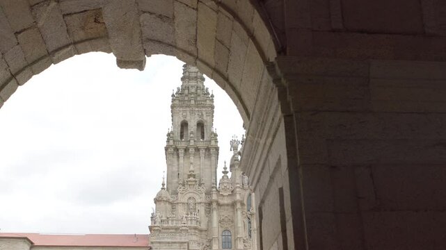Praza do Obradoiro or Obradeiro square in Santiago de Compostela, Spain. Famous Camino de Santiago World Heritage pilgrims' way of Cami&ntilde;o de Santiago final target. 4K walking under arches footage