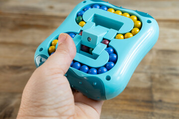 puzzle with balls in female hand, stress relief, brain exercise, attention deficit disorder, increase alertness, substitute bad habits such nail biting, hair twisting