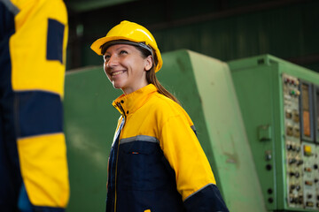 working woman : Caucasian mele and female manufacture technical or factory staff working with holding laptop computer standing at industry factory. Professional Mechanical Engineer