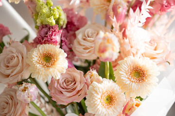 Elegant pastel floral arrangement with roses and gerbera daisies