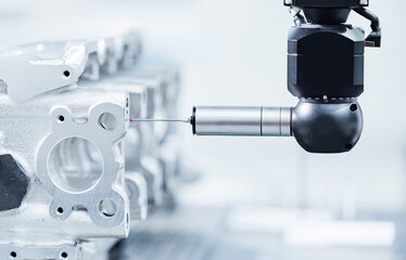 Cnc coordinate measuring machine inspecting engine part in precision engineering