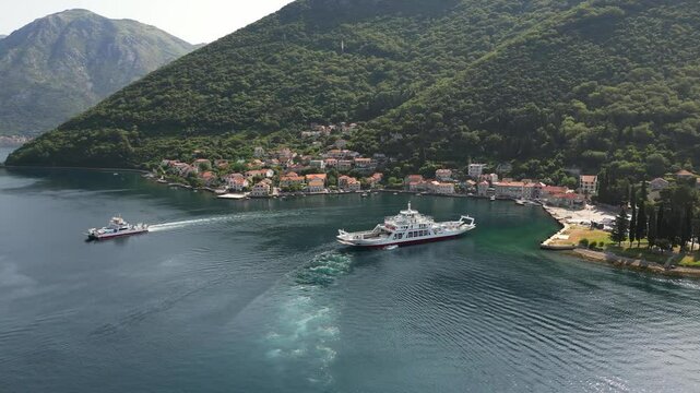 A drone flies over the village of Lepetane in Montenegro, where a passenger ferry is arriving to cross the Bay of Kotor