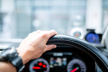 Modern car cockpit dashboard close-up. Element of design.Modern car cockpit dashboard close-up. Element of design,close-up of a latin man's hands, holding the steering wheel, while driving with a beau