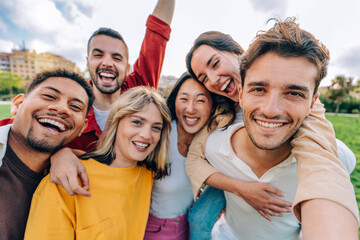Multiracial friends taking selfie picture with smart mobile phone outside - Group of young people smiling at camera outdoors - Friendship concept with guys and girls enjoying summer vacation