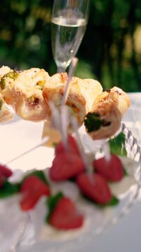 Sweet croissants with filling and strawberries at a festive dessert buffet. Banquet table at the event and holiday. Confectionery sweets close-up