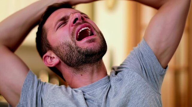 Emotional reaction: expressive man displaying frustration and disappointment at home