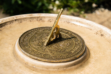 Vintage sundial bird bath showing 1:00 PM, combining timekeeping and garden charm in a single...
