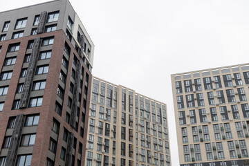 Modern apartment buildings in urban setting under cloudy sky