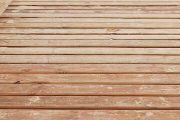 Wooden decking on the beach, close-up on the boards. Boardwalk. Background. Weathered wooden boards...