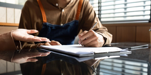 Entrepreneur taking notes during a collaborative discussion