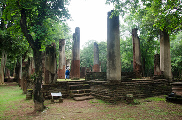 View landscape of buddha statue at Wat Phra Non in ancient building and ruins city of Kamphaeng Phet Historical Park