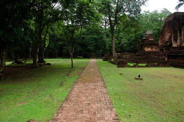 View landscape of buddha statue at Wat Phra Si Iriyabot in ancient building and ruins city of Kamphaeng Phet Historical Park