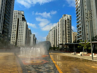 Fountain in the middle of a modern residential area. Multi-storey apartment buildings, Israeli city. Comfortable housing
