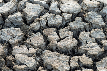 A rocky, cracked surface with a lot of dirt and debris