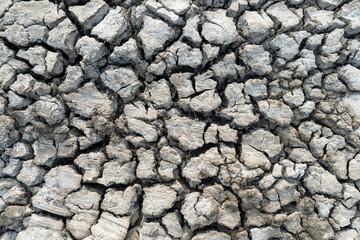 A barren, rocky landscape with large, jagged rocks scattered throughout